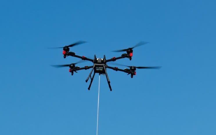 XAG heavy-lift drone flying with a load on the RevoSling line