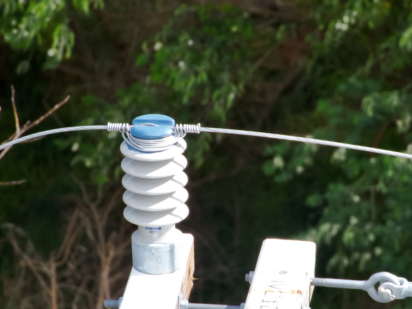 High-zoom drone photo of a power pole insulator and tie wire captured on a KC Drone Solutions inspection