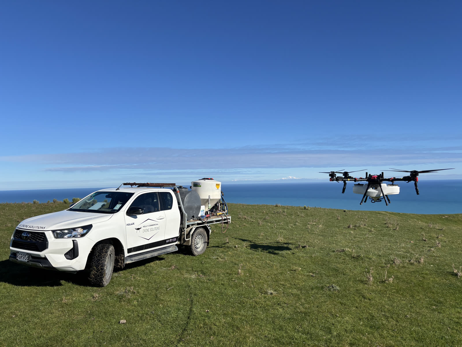 KC Drone Solutions service vehicle and XAG drone on a Wairarapa hill farm